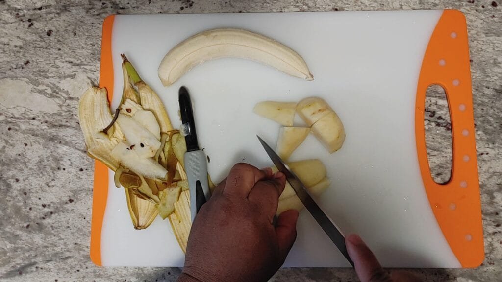 alt="Slicing pear into smaller pieces"