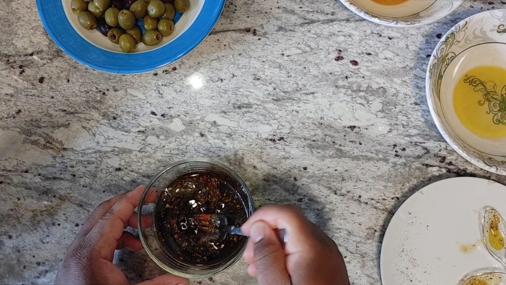 alt="Whisking Vinaigrette together"