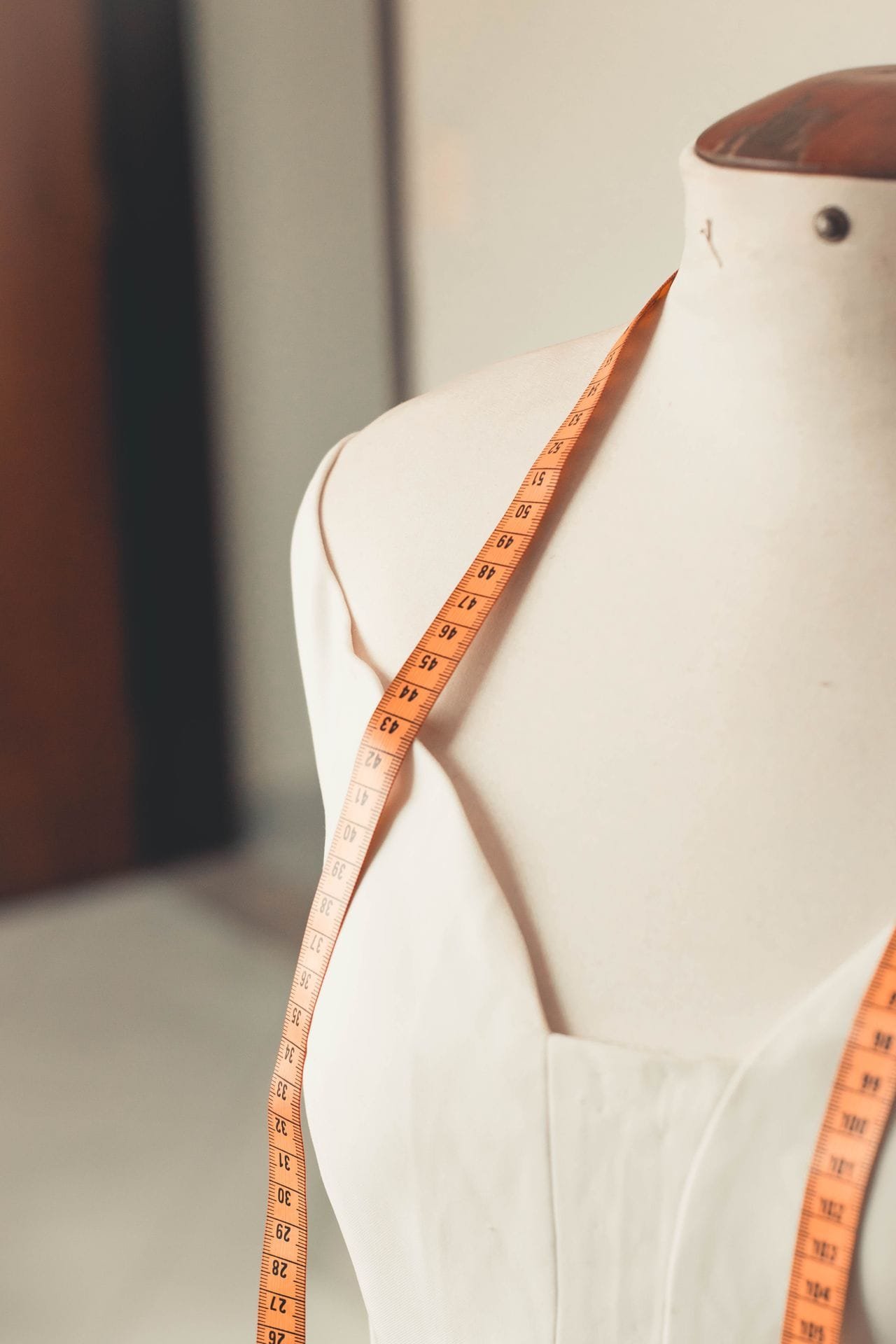 alt="manikin with measuring tape"