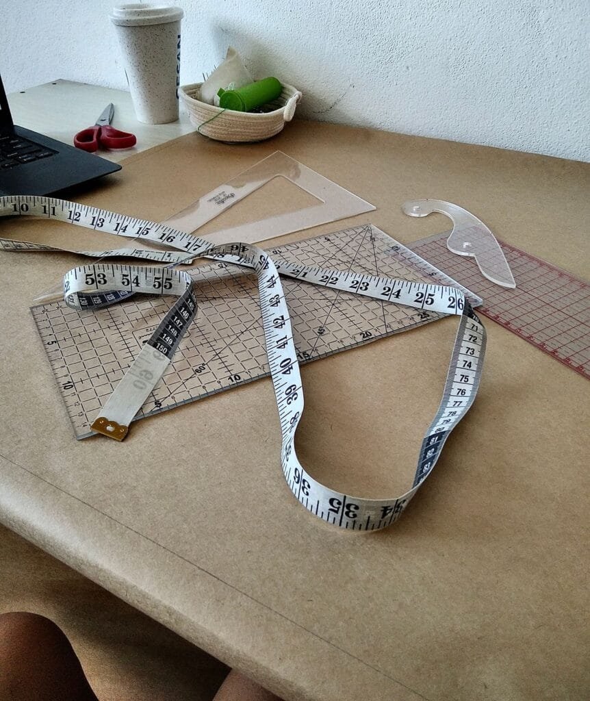 alt="Designer's table and measuring tools"
