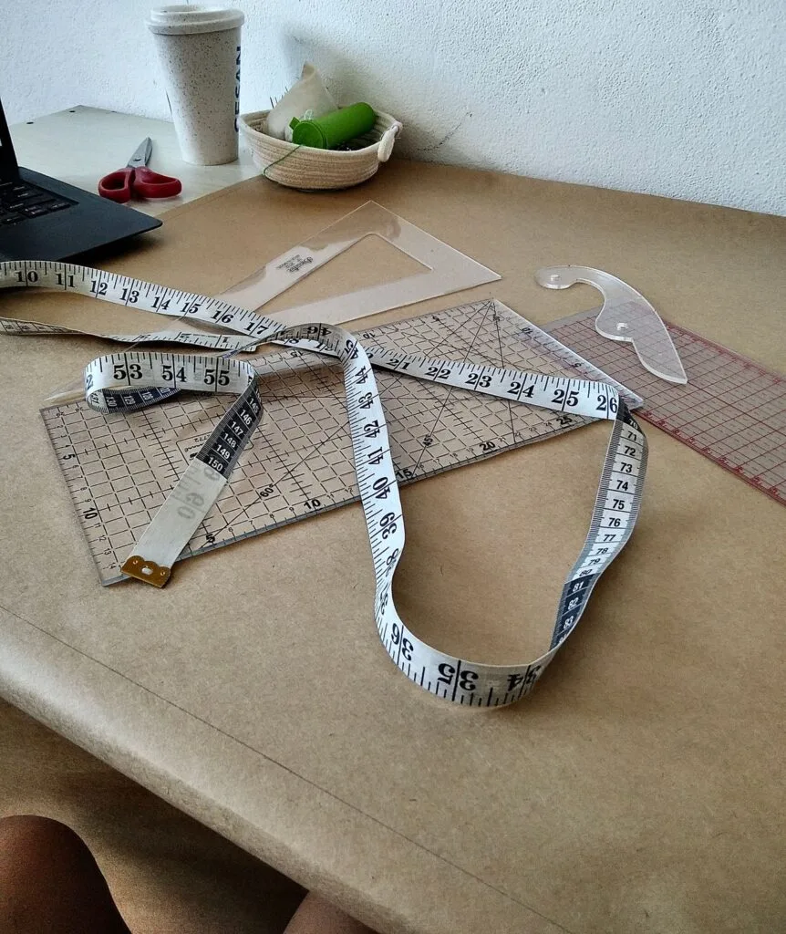 alt="Designer's table and measuring tools"