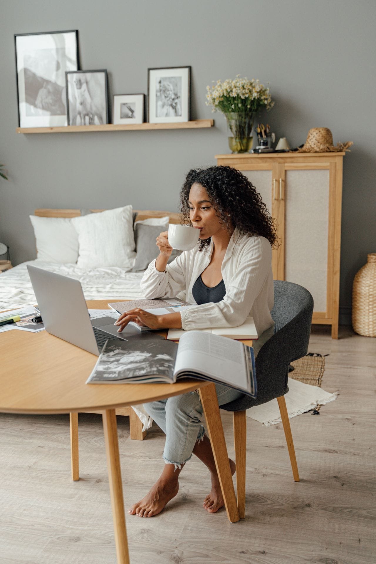 alt="Woman drinking coffee while working from home"