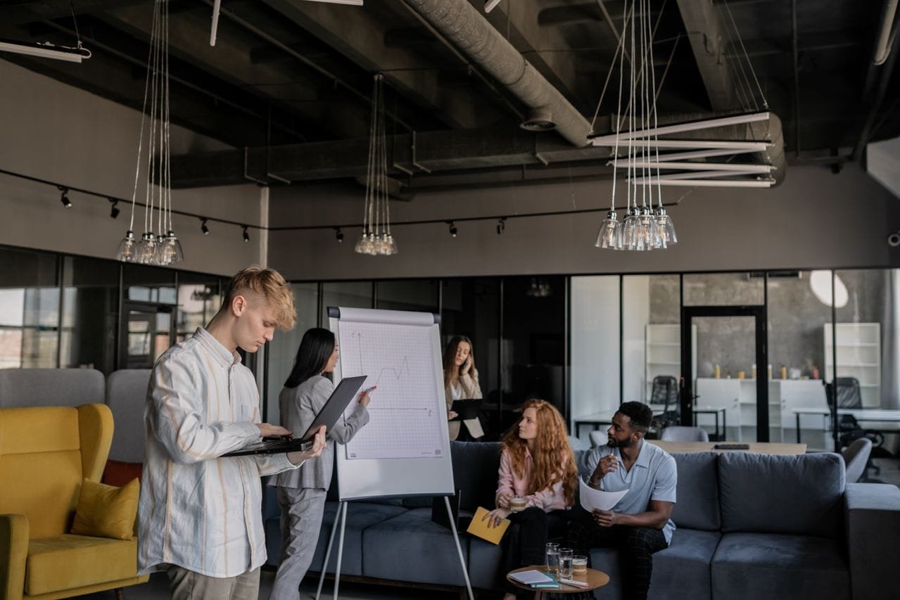 alt="Team meeting in the office"