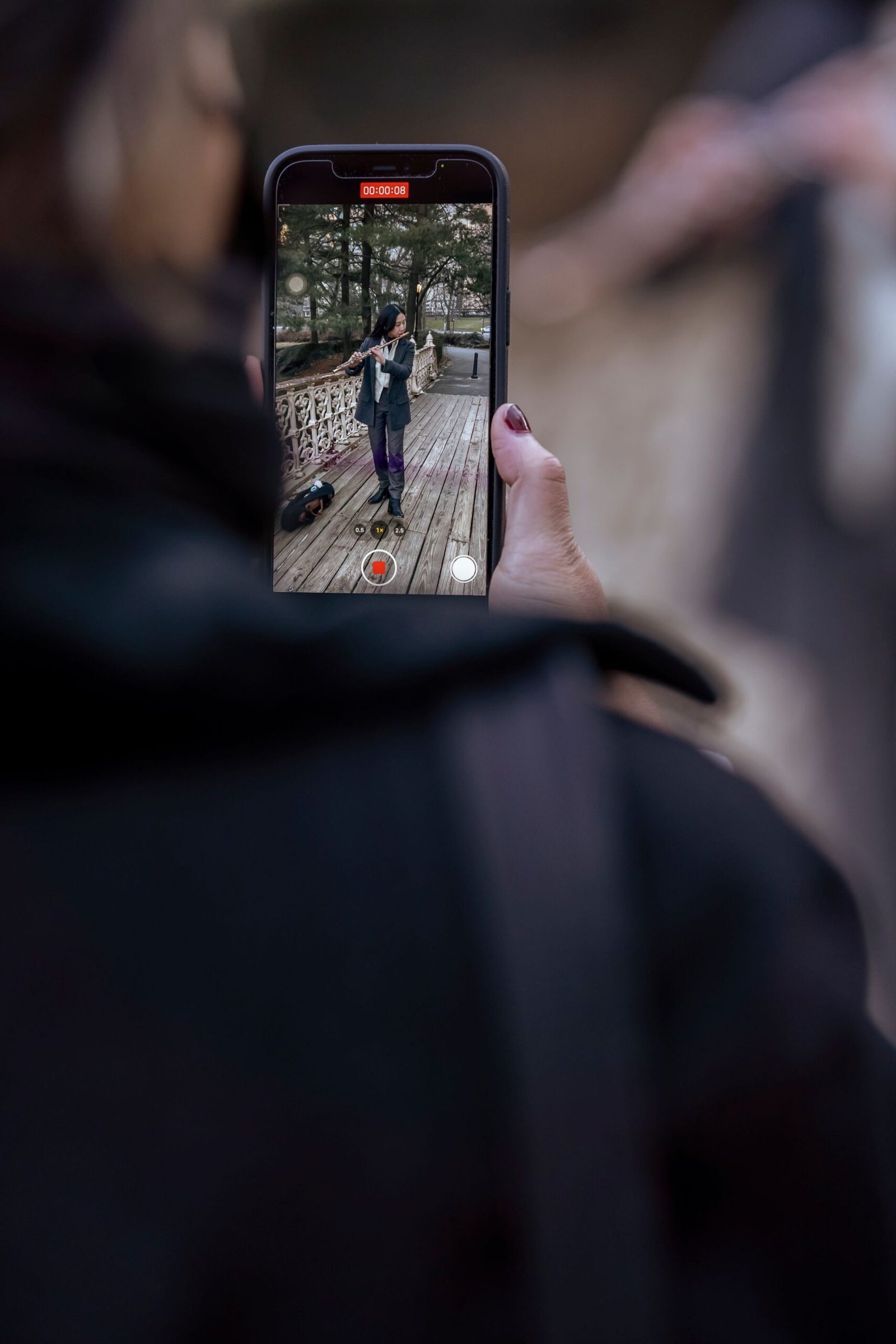 alt="Filming Person Playing Flute"