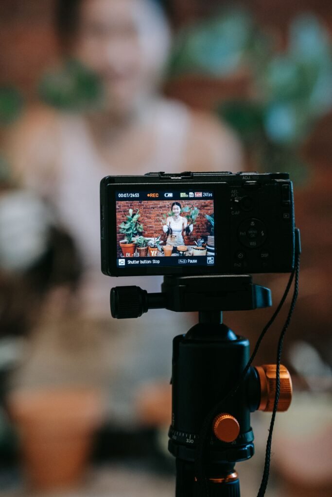 alt="Filming Person with Plants"